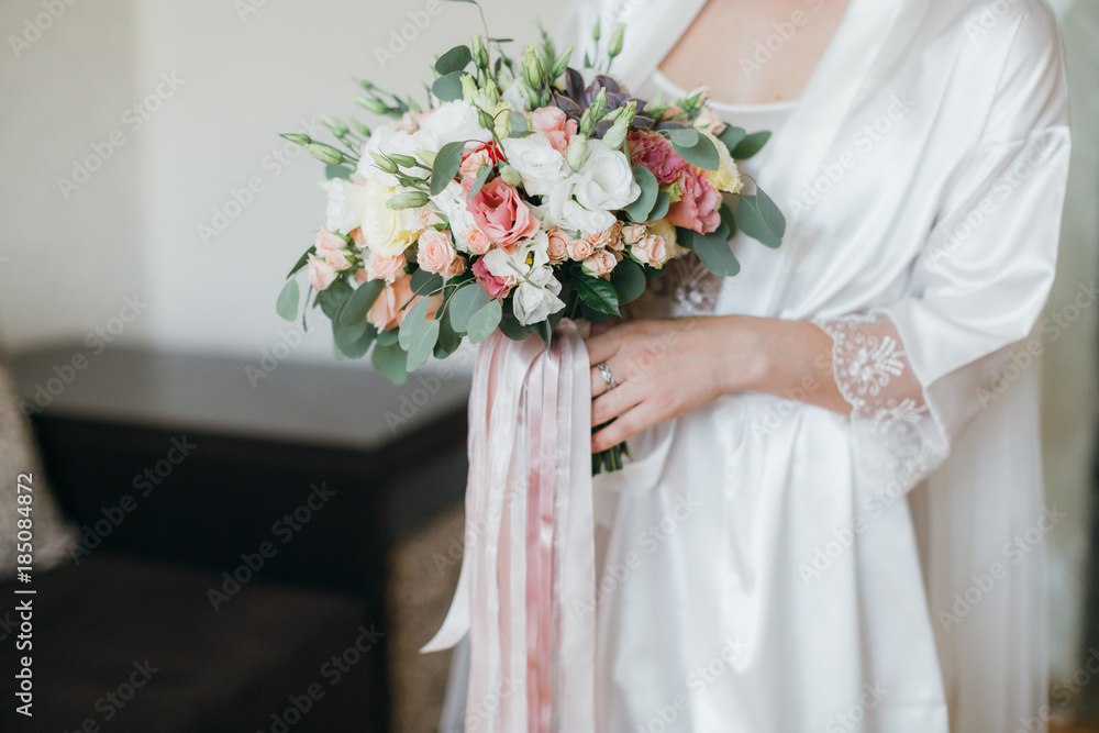 Bride holding beautiful bridal bouquet on the wedding.