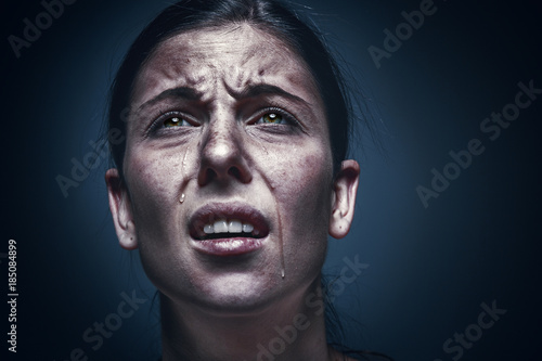 Close up portrait of a crying woman with bruised skin and black eyes