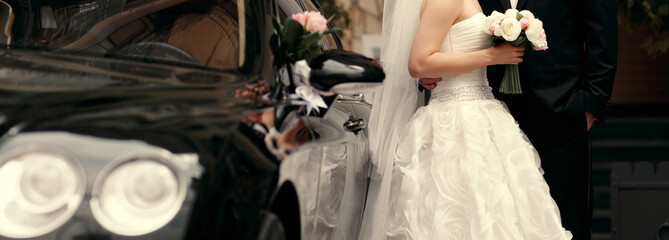 bride and groom by the car background