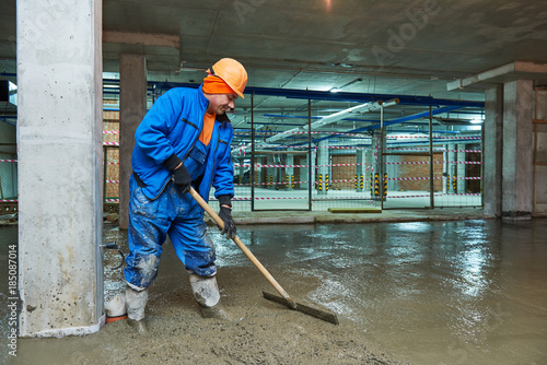 Canvas Print concrete floor construction. Worker with screeder