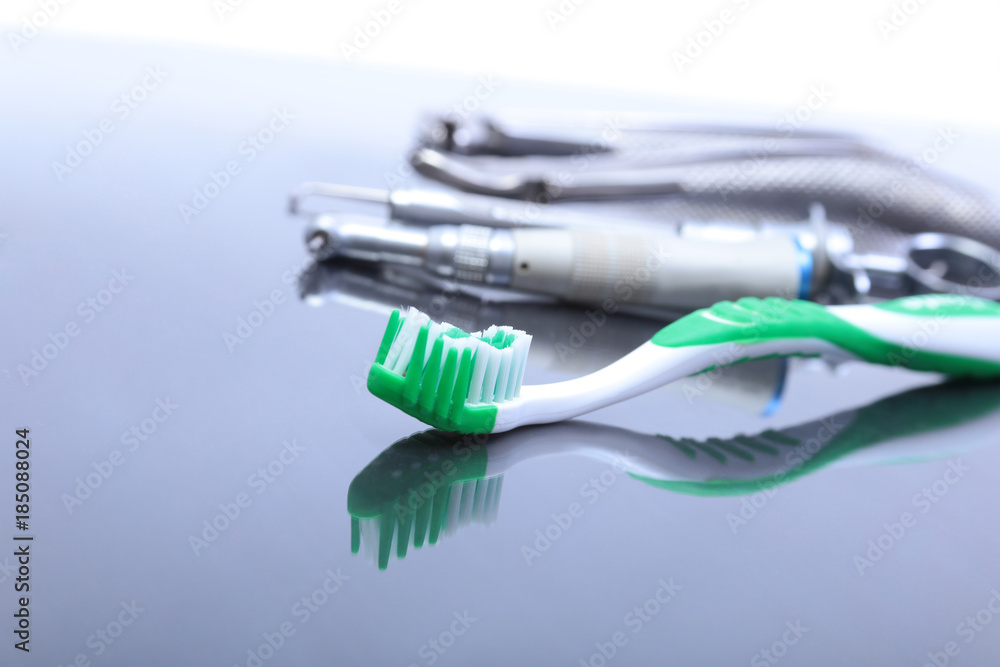 dental care toothbrush with dentist tools on mirror background. dental care toothbrush with dentist tools on mirror background.