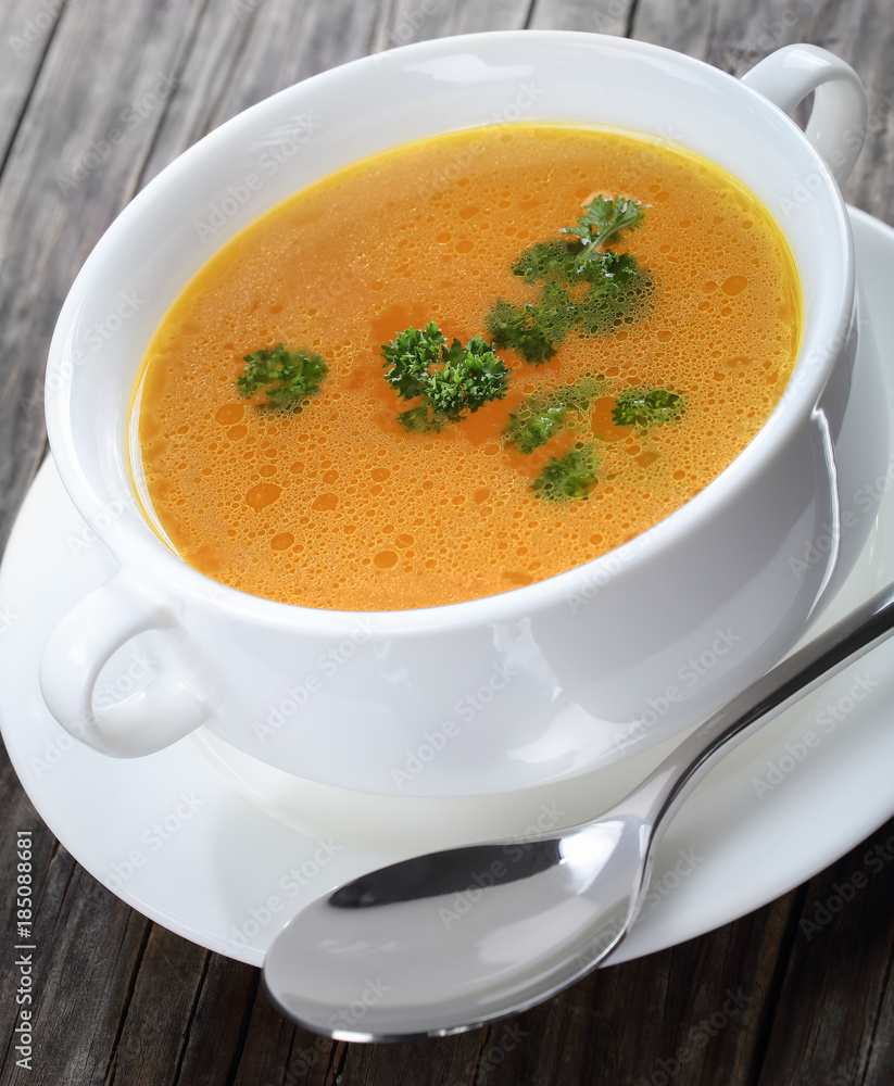 Chicken broth with parsley in a soup cup Chicken broth with parsley in a soup cup