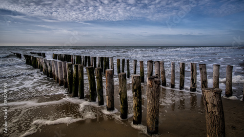 Pier during sunny weather with clouds at the beach in Vlissingen, Zeeland, Holland, Netherlands