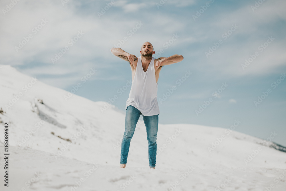 .Handsome young man dancing in the snow with bare feet. Taking joyful feelings, happy free and with dance. Lifestyle. .Handsome young man dancing in the snow with bare feet. Taking joyful feelings, happy free and with dance. Lifestyle.