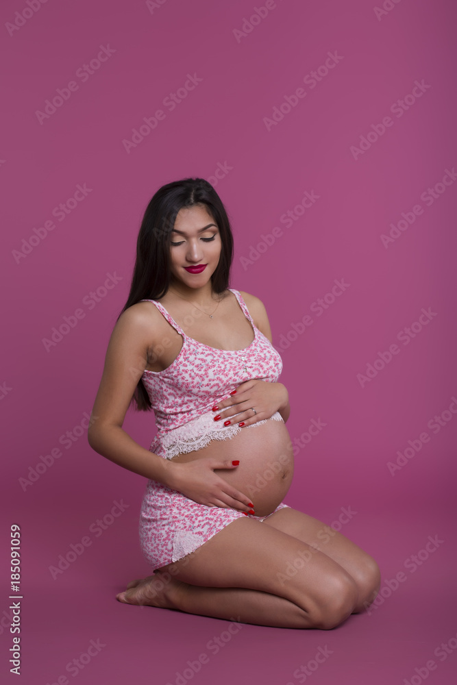 Cute pregnant girl in pink pajamas Cute pregnant girl in pink pajamas