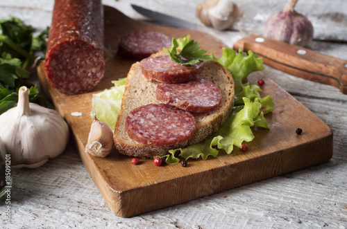 salami and bread on a wooden board