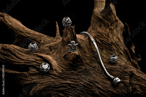 Pandora silver jeweler on wood with black background photo