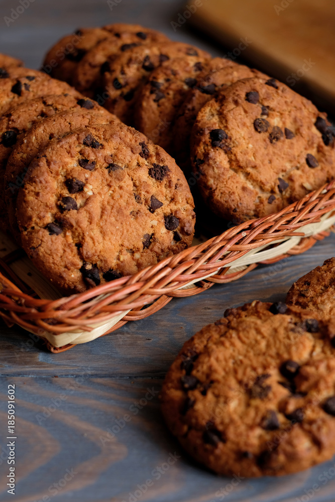 Fototapeta premium Chocolate cookies on wooden table. Chocolate chip cookies.