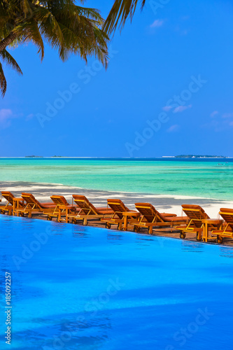 Loungers and pool on Maldives beach