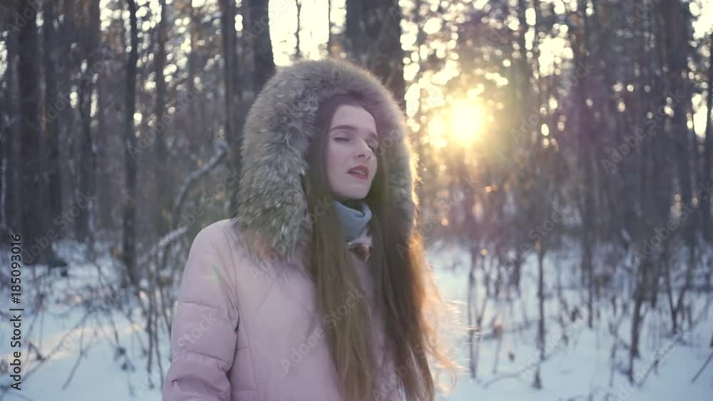 Young free beautiful girl walking through the winter forest, whirls of pleasure against the sunset. HD, 1920x1080, slow motion Young free beautiful girl walking through the winter forest, whirls of pleasure against the sunset. HD, 1920x1080, slow motion