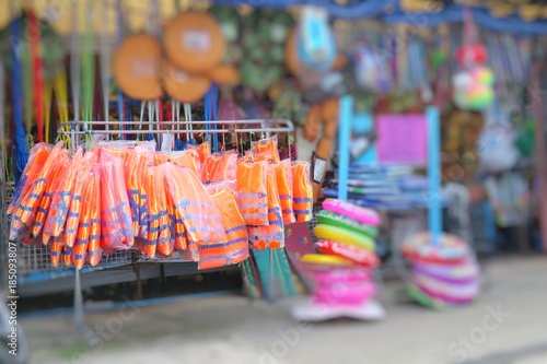 Life jacket in store, summer time at the beach. Selective focus with blurred background.