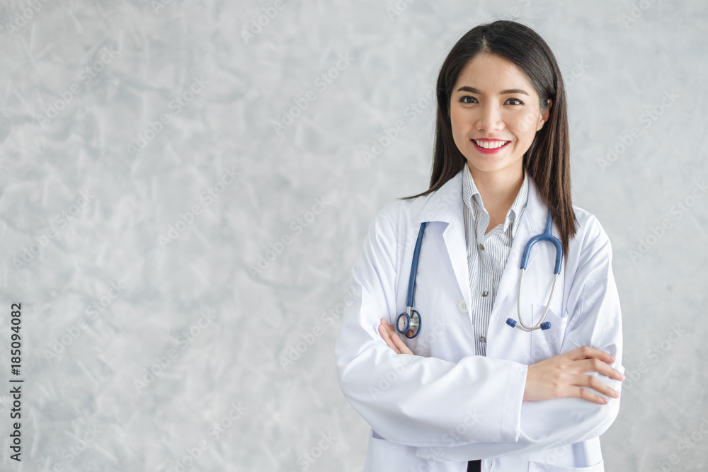 Asian woman doctor with stethoscope in uniform over background with copy space, medical concept