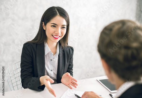 Asian business woman discussing/job interview with colleauge/boss for business meeting photo