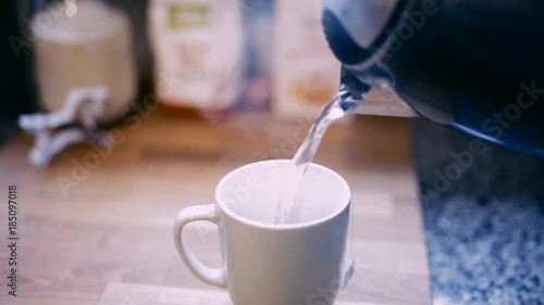 pouring tee in cup in winter holidays, preparation for Christmas bakery