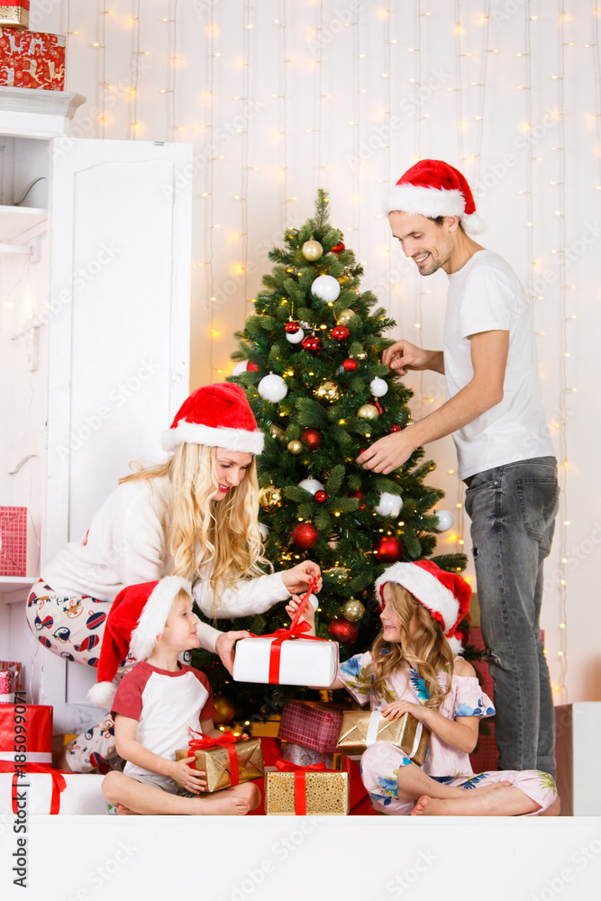 Happy family decorates Christmas pine Happy family decorates Christmas pine
