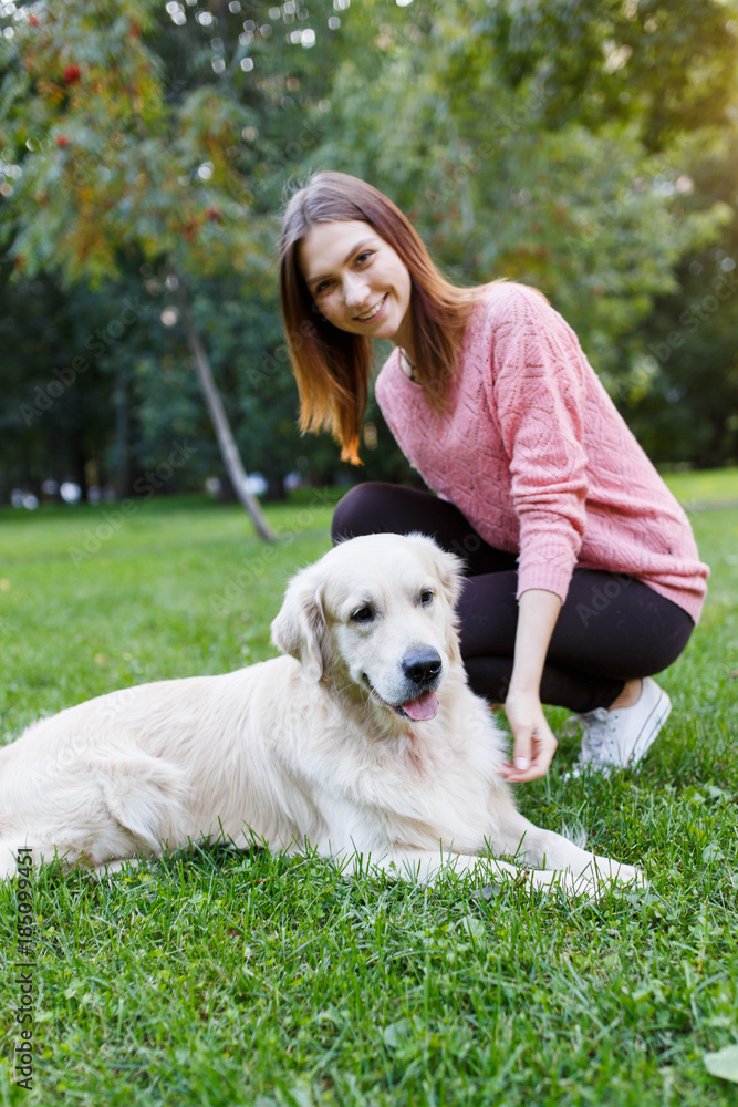 Image of woman with dog lying on lawn in summer park Image of woman with dog lying on lawn in summer park