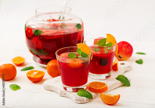 Sangria with fruits and mint on a white background