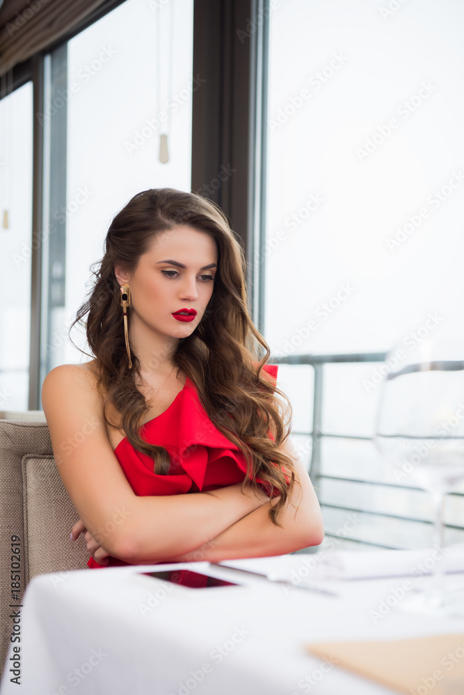 upset woman with arms crossed waiting for boyfriend on date in restaurant upset woman with arms crossed waiting for boyfriend on date in restaurant