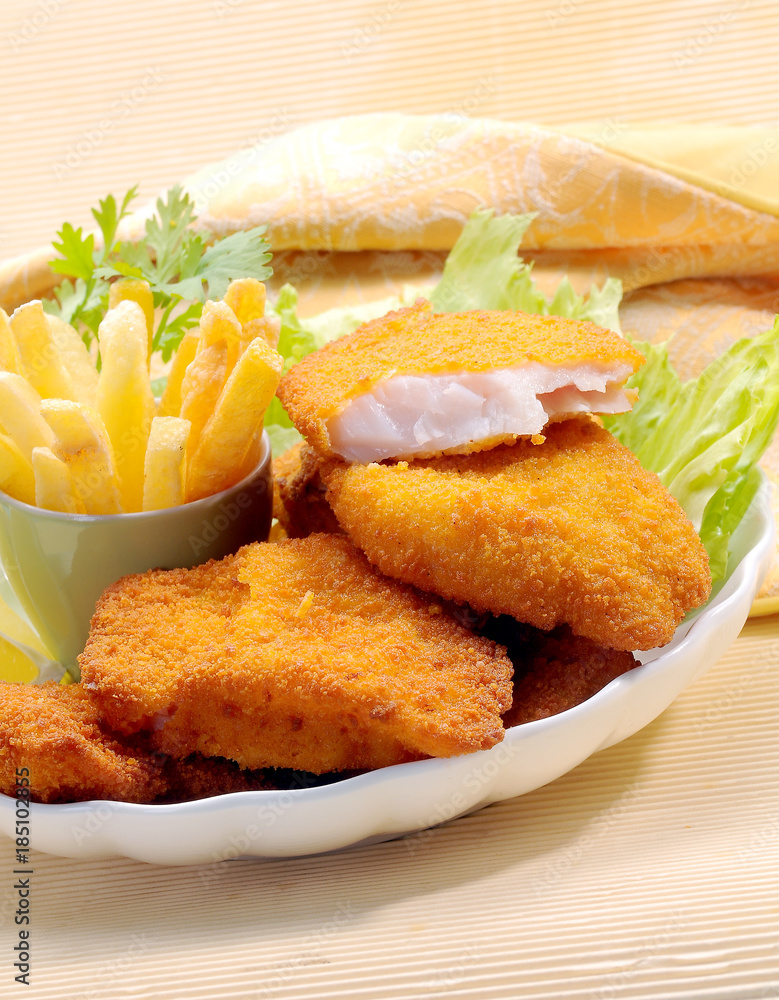 Breaded Fried fish with potato fries and tomato ketchup with lemon cherry tomato Breaded Fried fish with potato fries and tomato ketchup with lemon cherry tomato