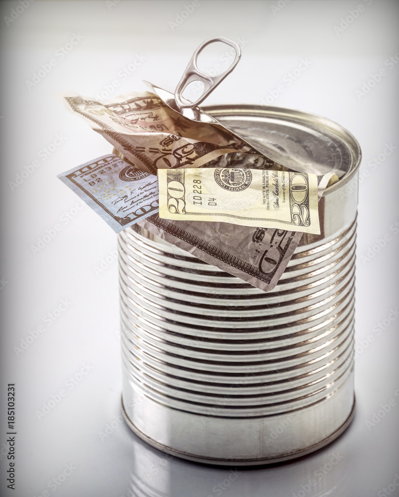 Canned cans full of dollar bills, conceptual image isolated on white background Canned cans full of dollar bills, conceptual image isolated on white background