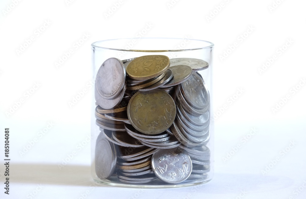 stacked indian rupee coins in a glass jar stacked indian rupee coins in a glass jar