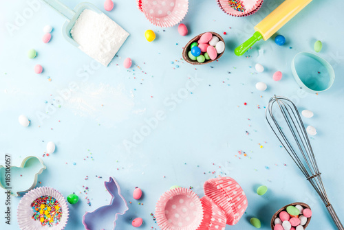 Fotografering Sweet baking concept for Easter,  cooking background with baking - with a rolling pin, whisk for whipping, cookie cutters, sugar sprinkling, flour