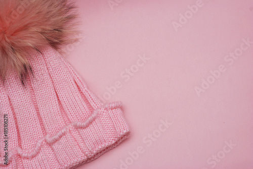 Cute knitted girl winter Pink hat isolated on Pink background