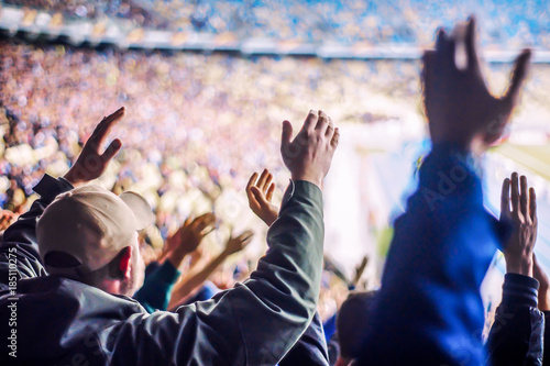 Football fans clapping on the podium of the stadium