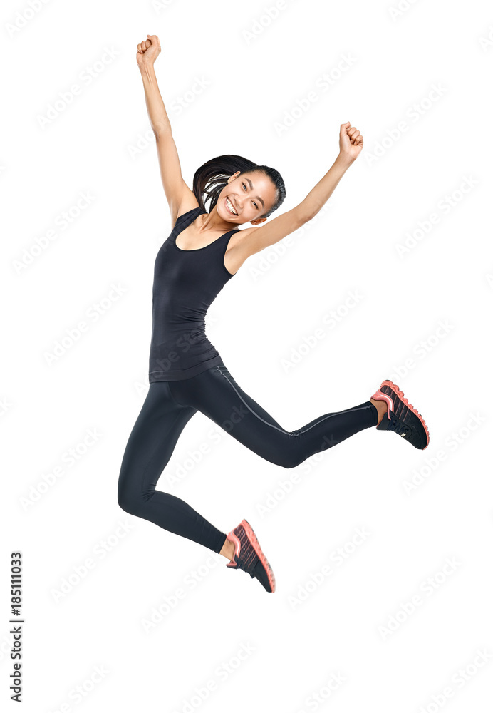 Young Asian woman in sports clothes and sneakers jumping