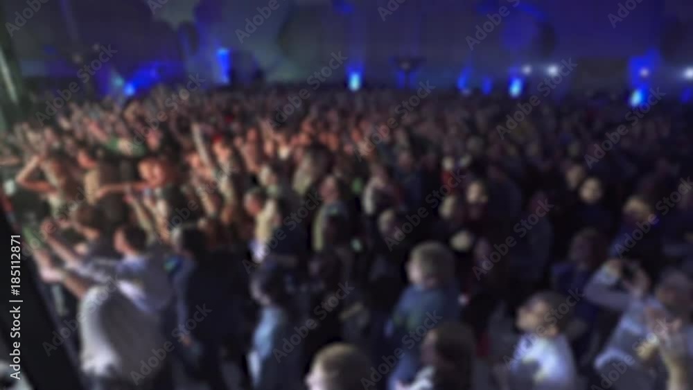 Concert in nightclub, blurred view of the crowd of dancing people.
Concert in nightclub, blurred view of the crowd of dancing people.