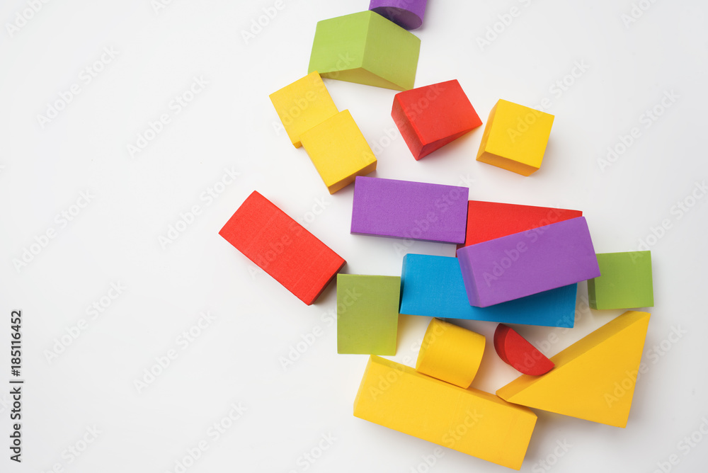 Multi-colored toy building blocks on a white background Multi-colored toy building blocks on a white background