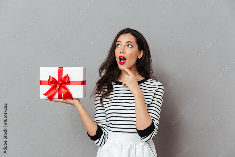 Portrait of an excited girl holding present box Portrait of an excited girl holding present box