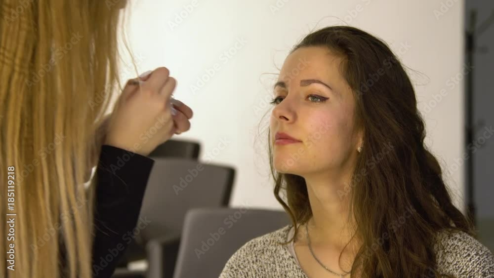 Young beautiful girl in beauty salon. Make-up artist does make-up. 4K. Young beautiful girl in beauty salon. Make-up artist does make-up. 4K.