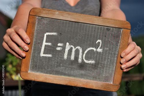 Vászonkép theory of relativity written with chalk on slate shown by young female