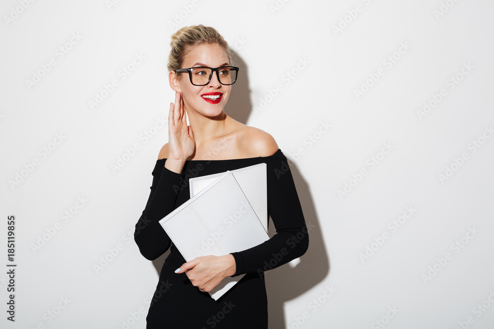 Fototapeta premium Pleased business woman in dress and eyeglasses holding documents