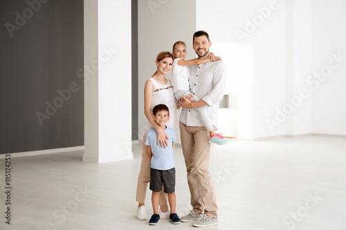 Happy family in new empty flat