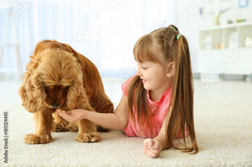 Cute little girl with dog a...