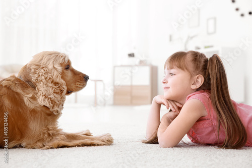 Cute little girl with dog a...