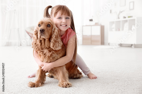 Cute little girl with dog a...