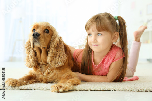 Cute little girl with dog a...