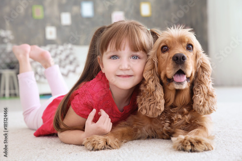 Cute little girl with dog a...