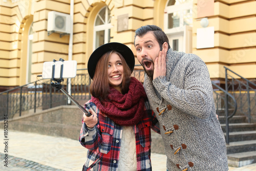 Young adorable couple takin...