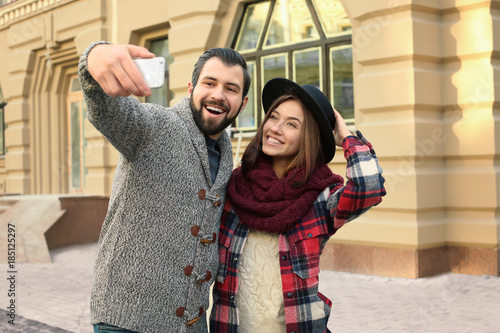 Young adorable couple takin...