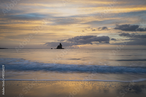 Beautiful sunrise landsdcape of idyllic Broadhaven Bay beach on Pembrokeshire Coast in Wales photo