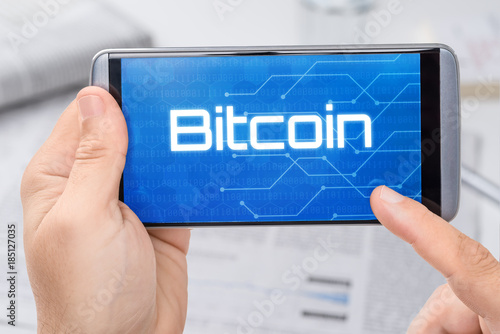 Smartphone mit dem Text Bitcoin auf dem Display