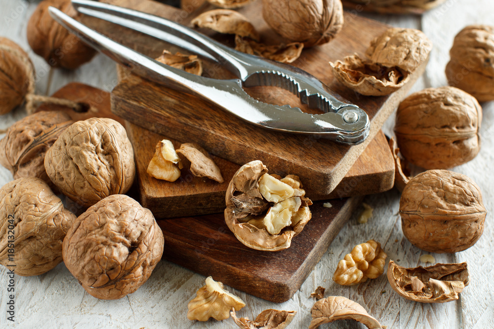Fototapeta premium Fresh walnuts on an old wooden table