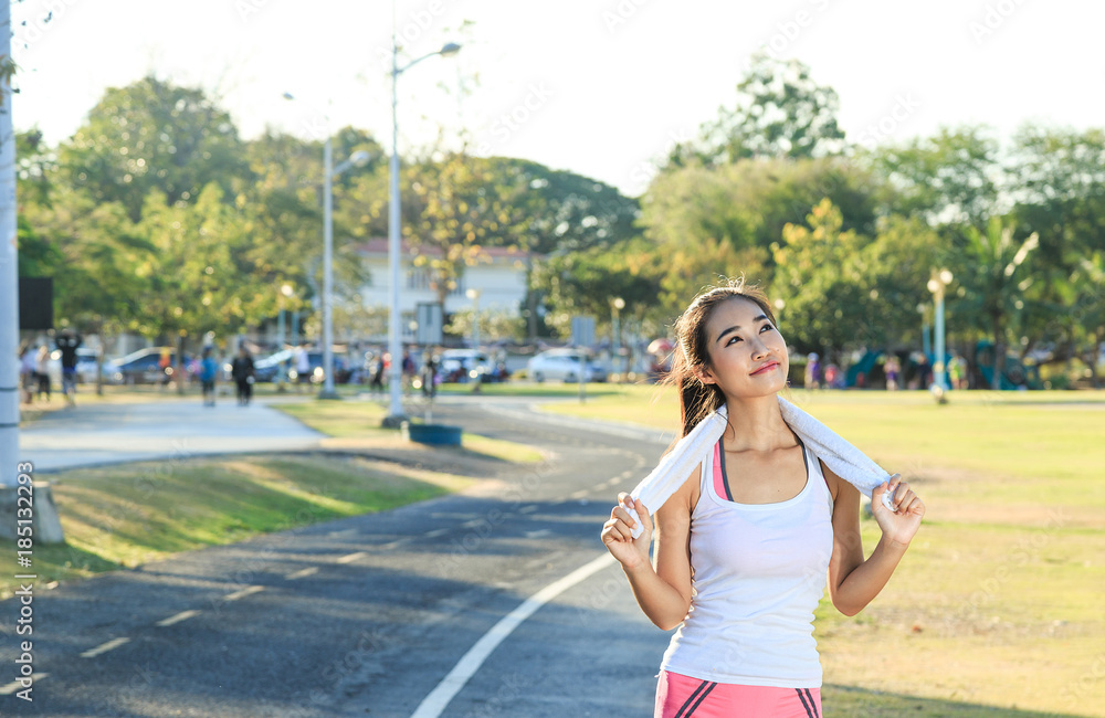 A women is exercising and relaxing at the park. A women is exercising and relaxing at the park.