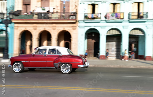 Panning shot of American vintage car travelling in Paseo de Marti, Old Havana, Cuba © akturer