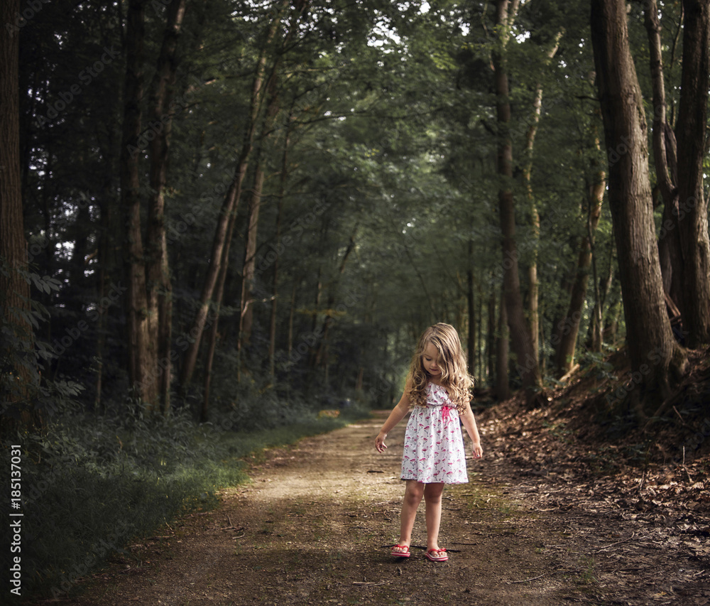 Girl standing on dirt road in forest Girl standing on dirt road in forest