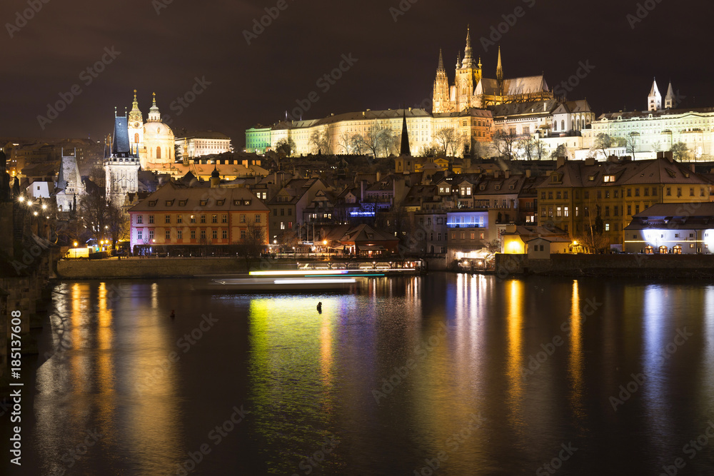 Christmas night snowy Prague Lesser Town with Charles Bridge and Prague Castle, Czech republic